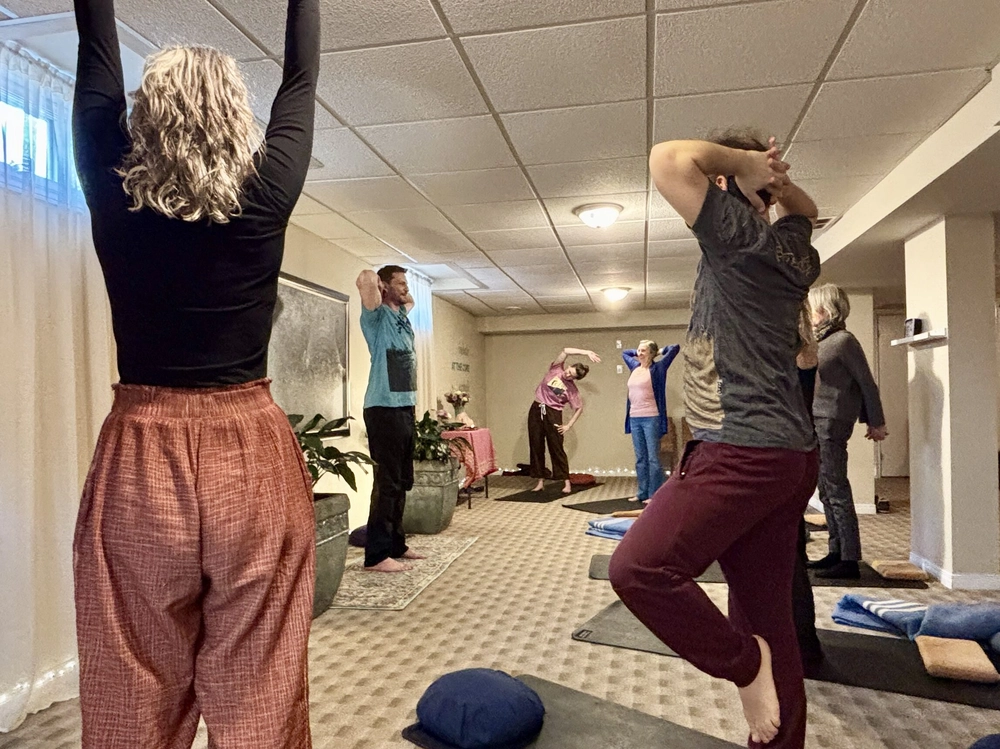 Instructor guiding students through a pose in a gentle yoga class