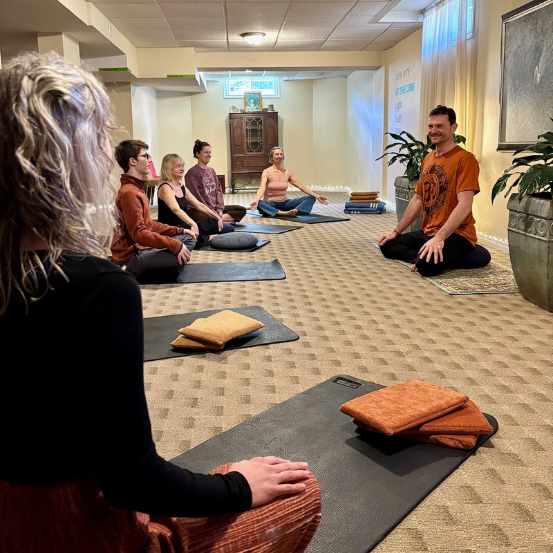 Students and instructor holding a pose together in a yoga class