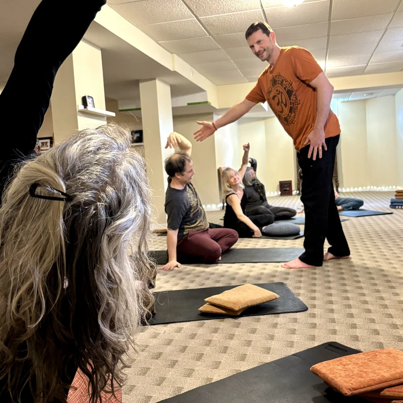 Students and instructor holding a pose together in a senior's yoga class