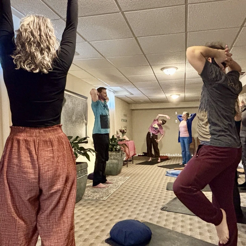 Students being guided by an instructor in a yoga class for seniors