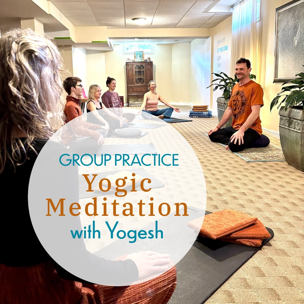 Group meditation class in London Ontario with students seated on mats in a peaceful studio setting during a guided practice.