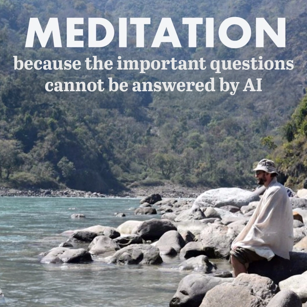 Man sitting quietly on river rocks reflecting in nature, symbolizing the deeper purpose behind meditation classes in London ON.