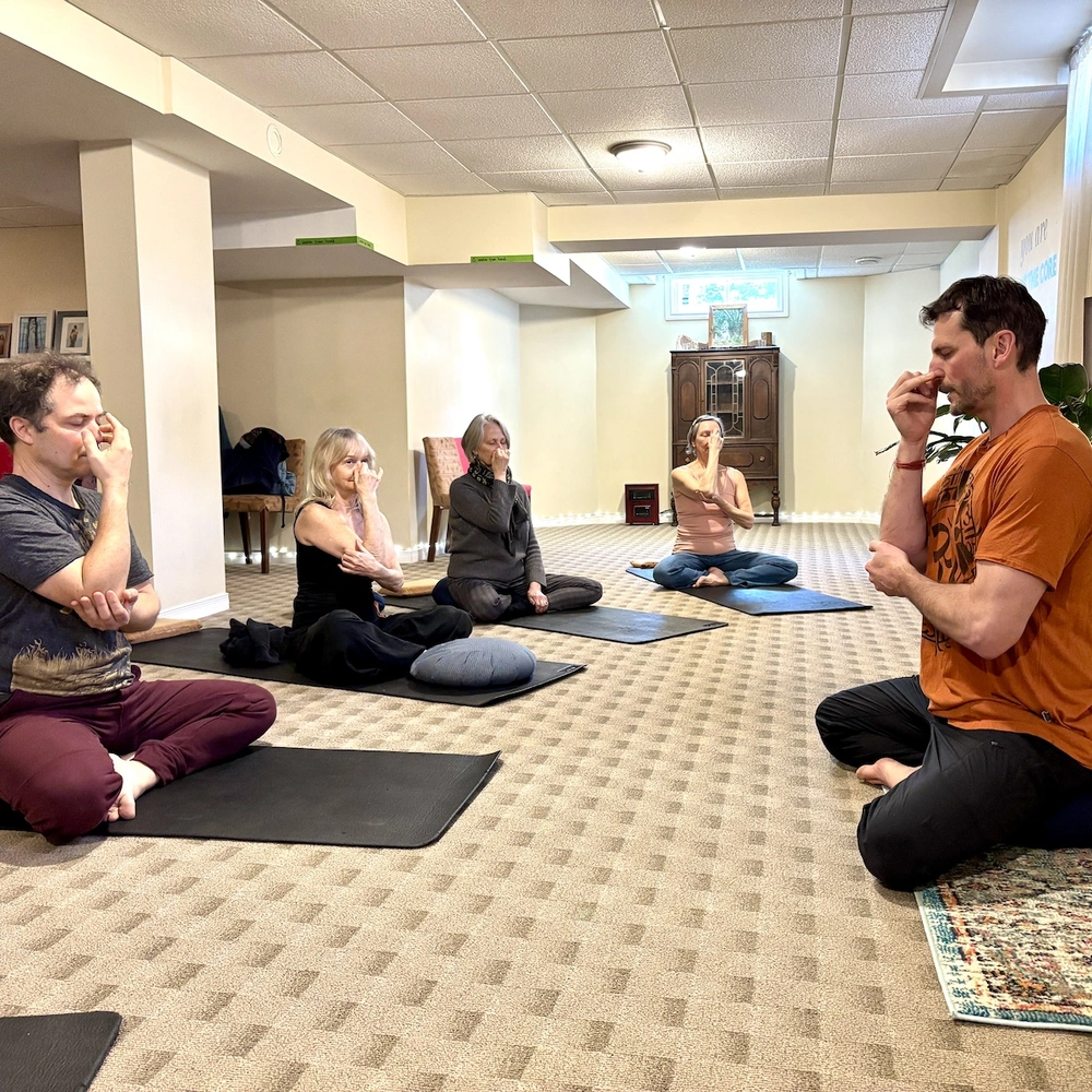 Students practicing breathing techniques during a focused meditation class session in London Ontario.
