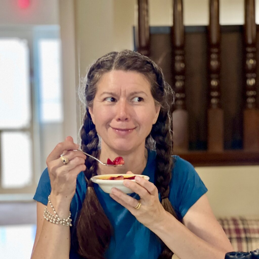 At The Core Teacher Shankari Smiling in a beautiful picture while she eats one of her signatue dishes