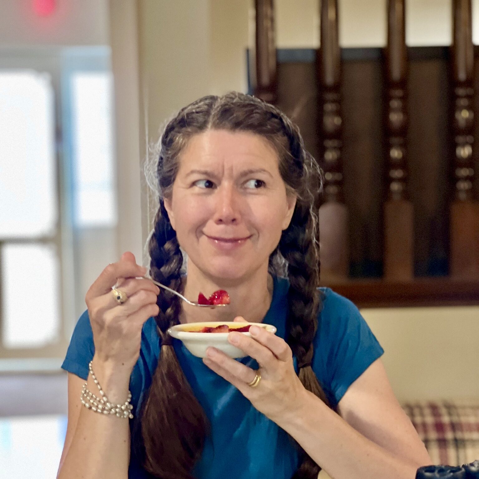 At The Core Teacher Shankari Smiling in a beautiful picture while she eats one of her signatue dishes