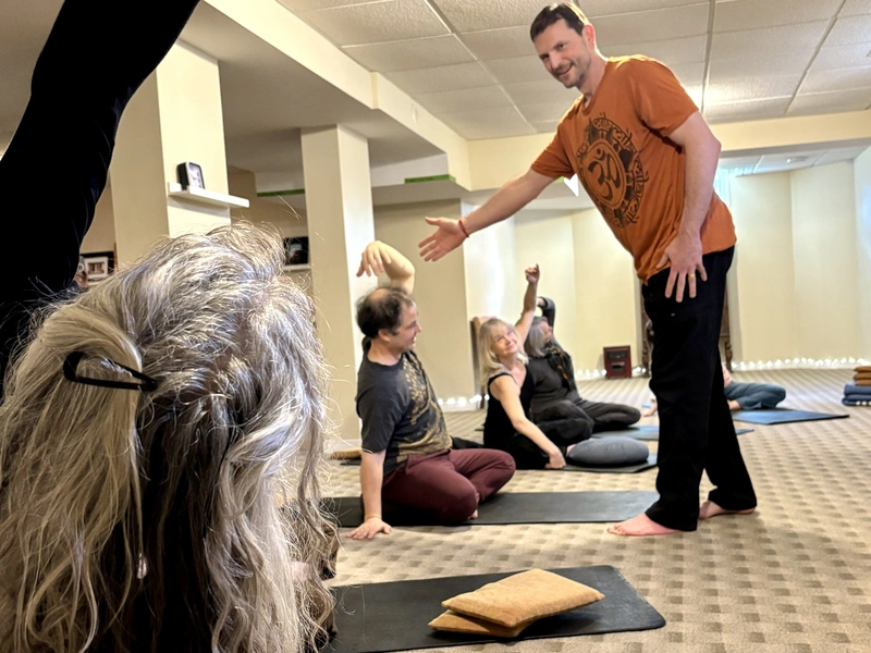 Yogesh guiding a small gentle yoga class at AT THE CORE in London, Ontari