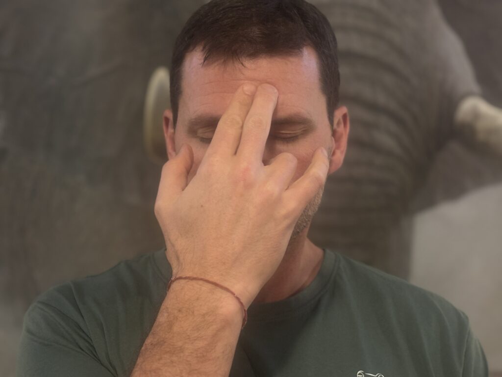 Yogesh Van Acker practicing alternate nostril breathing, or Nadi Shodhana in the At The Core Yoga Studio