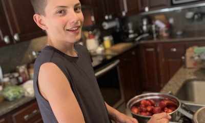 Teenager is cooking with strawberries